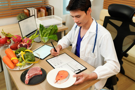 professional nutritionist in uniform writing notes on the table with different healthy products and drawings on the topic of healthy eating.の写真素材