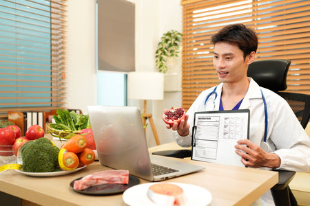 Young nutritionist male giving consultation to patient and making diet plan through meeting on video call Healthy lifestyle nutrition and diet concept.の写真素材