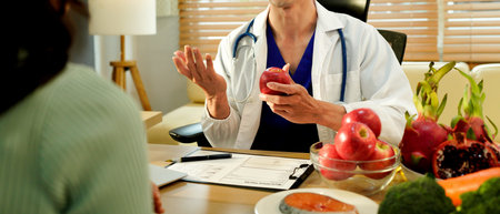 Dietician, male nutrition specialist consulting woman, developing healthy diet, dietary program. Dietary consultant asking, giving male patient advice, help, nutritional information, new meal plan.の写真素材