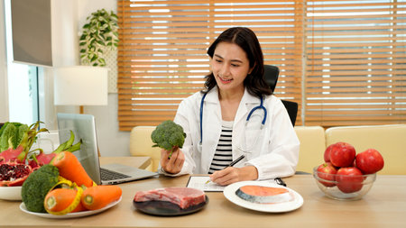 professional nutritionist in uniform writing notes on the table with different healthy products and drawings on the topic of healthy eating.の写真素材