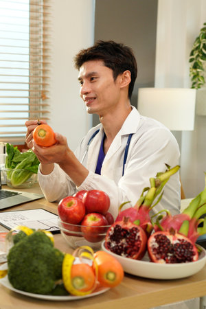 Dietician, male nutrition specialist consulting woman, developing healthy diet, dietary program. Dietary consultant asking, giving male patient advice, help, nutritional information, new meal plan.の写真素材