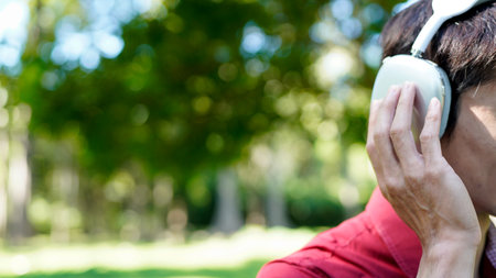 Close-up Man listening to music outdoors.の写真素材