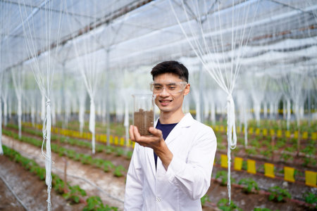 Researcher conducts soil analysis at a plant growth site to improve agricultural practices and...