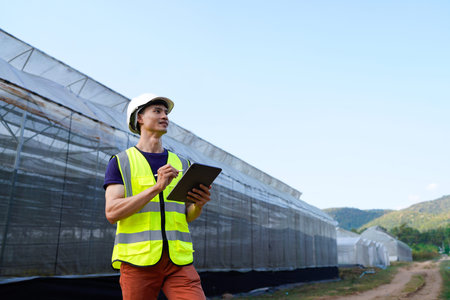 A professional architect inspect a modern greenhouse with technology, ensuring growth and...