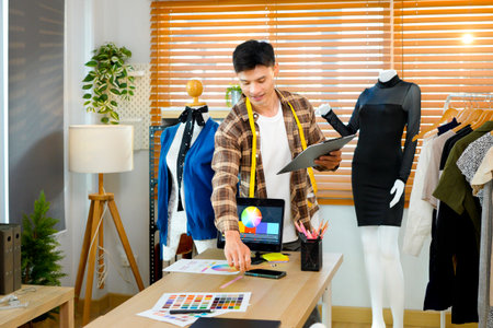 men working as fashion designer choosing on color chart for clothes at workplace studio.の写真素材