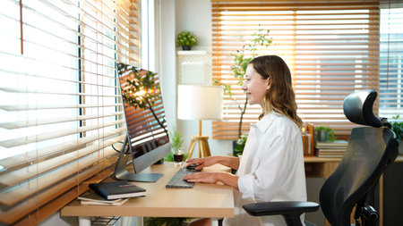 Creative website designer woman at computer or desktop pc working on internet SEO for digital...
