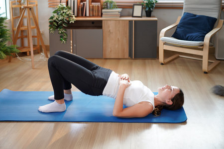 Young sporty woman does yoga on mat at home. Healthy lifestyle. Sport wellness people lifestyle...