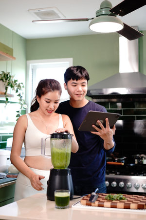 Smoothie, tablet and blender with couple in kitchen for nutrition, search and fitness diet. Detox,...