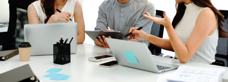Close up shot business people team meeting in conference room in company. Businessman pointing pen...