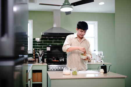 process of making traditional healthy Japanese drink with natural ingredients. closeup a man...