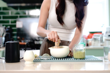 process of making traditional healthy Japanese drink with natural ingredients. closeup a woman...