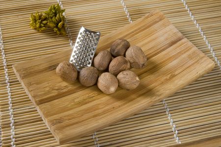Nutmeg on wooden dish. Myristica fragrans Indonesia.の写真素材