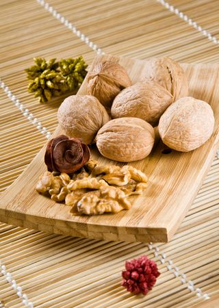 Walnut fruits on wooden dish. Juglans.