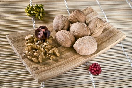 Walnut fruits on wooden dish. Juglans.の写真素材