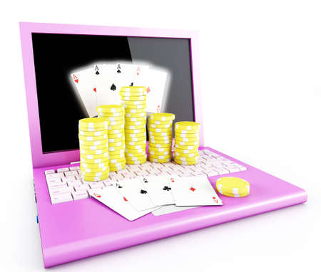 Gambling chips and poker cards on a laptopの写真素材