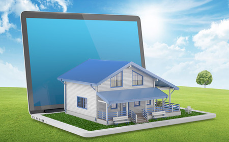 Mobile house project. House comes out from laptop on green lawn. 3D Renderの写真素材