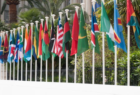 International flags in front of institutional building.の写真素材