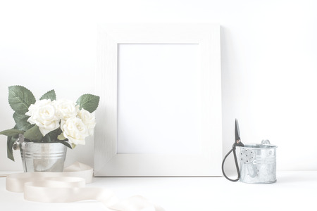 Picture frame with flower bouquet on wooden table.の写真素材