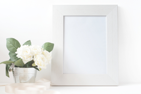 Picture frame with flower bouquet on wooden table.の写真素材