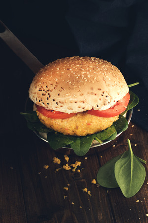Vegetarian burger with carrot and quinoa on wooden table.の写真素材