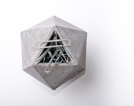 Hexagon pot isolated on a white background with a soft shadow filled with paper clips
