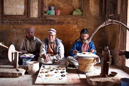 AGRA JANUARY 22: Three unidentified masters of cutting marble pose during the cutting of marble in...