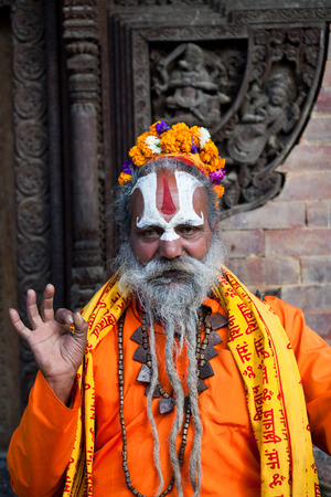 KATHMANDU, NEPAL - NOVEMBER 14: Shaiva sadhu seeks alms at Durbar Square on November 14, 2009 in Kathmandu, Nepal.のeditorial素材