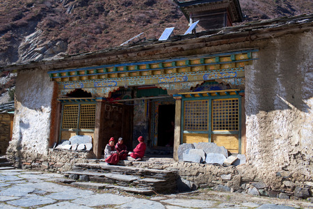 MU GOMPA, TSUM VALLEY, NEPAL - NOVEMBER 23: Three young buddhist monks learning together at Mu Gompa Monastery on November 23, 2009 in Tsum Valley, Nepal.のeditorial素材
