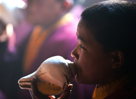 LHO, GORKHA, NEPAL - NOVEMBER 28: Buddhist monk Lhakpa Dorje, 9, poses for a photo during puja ceremony in Lho monastery on November 28, 2009 in Manaslu conservation area, Nepal.のeditorial素材