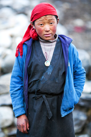 LHO, MANASLU CONSERVATION AREA, NEPAL - NOVEMBER 29: Tibetan girl Pema, 14, poses for a photo on the road to Lho village on November 29, 2009 in Gorkha District, Nepalのeditorial素材