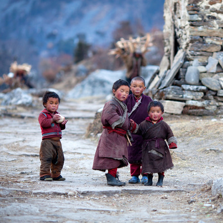 Nepalese kids in national clothes poses for a photo on November 29, 2009 in Gorkha District, Manaslu Area, Nepalのeditorial素材
