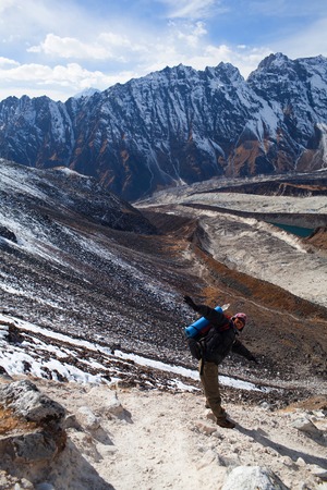 GORKHA, NEPAL - DECEMBER 02, 2009: Sherpa trekking guide walking across Larke Pass in Manaslu Nationa Park, Nepalのeditorial素材