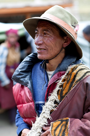 DHO TARAP, NEPAL - SEPTEMBER 10: Tibetan man in national clothesl walking around gompa on September 10, 2011 in Dho Tarap village, Upper Dolpo, Nepalのeditorial素材