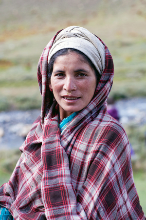 DHO TARAP, DOLPO, NEPAL - SEPTEMBER 11: Tibetan woman in national clothes poses for a photo during Dho Tarap Full Moon Festival on September 11, 2011 in Dho Tarap village, Dolpo district, Nepalのeditorial素材