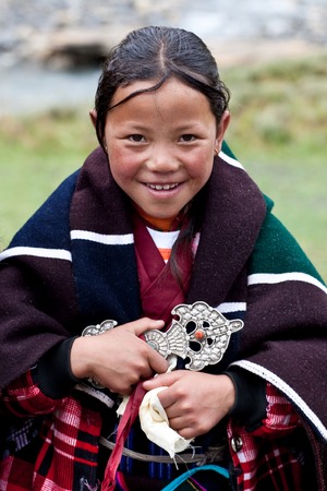 DHO TARAP, NEPAL - SEPTEMBER 11: Tibetan girl poses for the photo during the Dho Tarap Full Moon Festival on September 11, 2011 in Dolpo, Nepalのeditorial素材