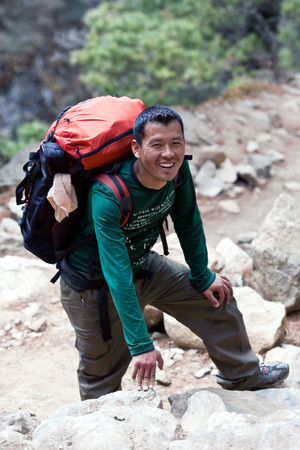 Sherpa trekking guide walking across mountain pass on March 6, 2010 in Sagarmatha National Park, Nepal Himalayaのeditorial素材