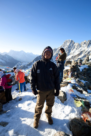 Gokyo, Nepal - March 12, 2010: Sherpa trekking guide walking across mountain pass in Sagarmatha National Park, Nepal Himalayaのeditorial素材