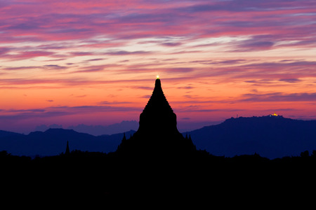 Silhouette of ancient pagoda at sunset in Bagan Archaeological zone, Myanmarの写真素材