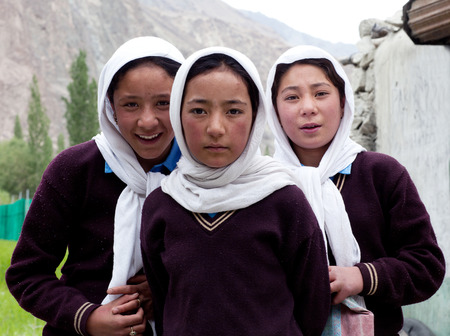TURTUK, INDIA - JUNE 13: Balti students poses for a photo during their break time on June13, 2012 in Turtuk Village, Ladakh, Jammu and Kashmir, Indiaのeditorial素材