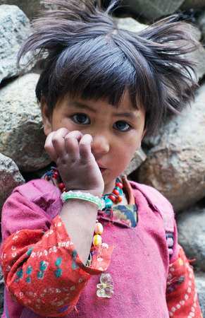 TURTUK, INDIA - JUNE 13, 2012: Shoolgirl from Baltistan poses for a photo during her break time in Turtuk Village, Ladakh, Indiaのeditorial素材