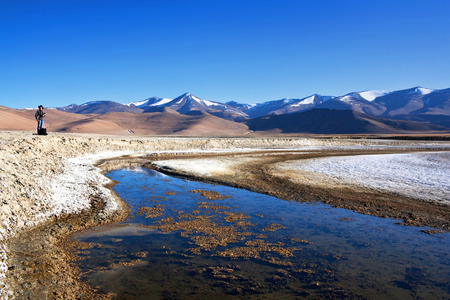 LADAKH, INDIA - JUNE 20, 2012: Tourist walking on Tso Kar salt water lake in Ladakh, North India. Tso Kar located in Rupsa valley, nearly 240 km southeast of Leh at a height of around 4,500 m and 28 km long.のeditorial素材