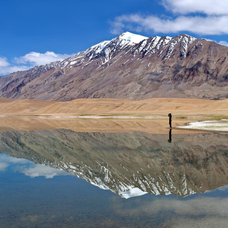 An unidentified photographer walking on Thatsang Karu lake in Ladakh, Jammu and Kashmir State, India