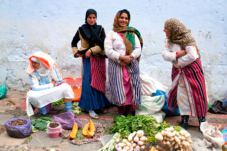 CHEFCHAOUEN, MOROCCO - JANUARY 2, 2014: Smiling women poses for a photo in the souk in medina of Chefchaouen.のeditorial素材