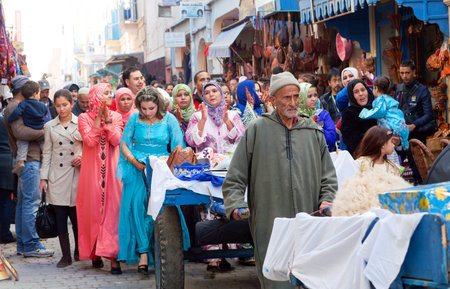 ESSAOUIRA, MOROCCO - JANUARY 15, 2014: Participants of traditional Muslim wedding ceremony walking on the street.のeditorial素材