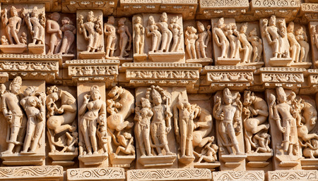 Ancient bas-relief at famous erotic temple in Khajuraho, India. Most Khajuraho temples were built between 950 and 1050 by the Chandela dynasty.の写真素材