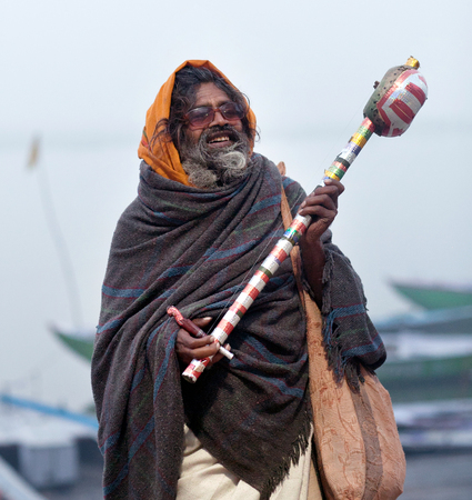 VARANASI, INDIA - JANUARY 3, 2016: Sadhu (Holy man) seeking alms at Dasashvamedh Ghat.のeditorial素材