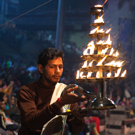 VARANASI, INDIA - JANUARY 3, 2016: Indian Brahmin conducts religious Ganga Maha Aarti ceremony (fire puja) at Dashashwamedh Ghat in Varanasi, Uttar Pradesh, Indiaのeditorial素材
