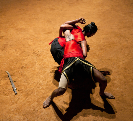 KERALA, INDIA - JANUARY 19, 2016: Indian fighters performing Kalaripayattu marital art demonstrationのeditorial素材