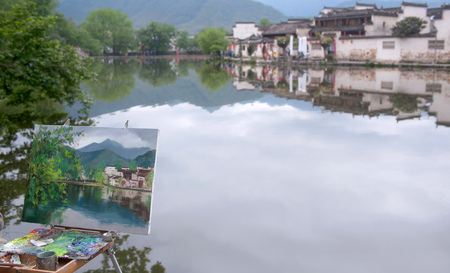 HONGCUN, CHINA - APRIL 20, 2014: Easel with a picture in the background of a landscape in Hongcun Village, Anhui Provinceのeditorial素材