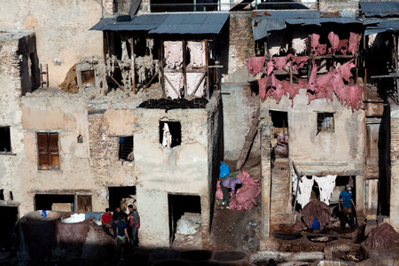 FEZ, MOROCCO - JANUARY 4, 2014: Men working hard in the tannery souk in Fez, Morocco. The tannery souk of weavers is the most visited part of the 2000 years old city.のeditorial素材